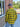 Construction detail of men's flannel yellow shirt, highlighting stitching and material grain