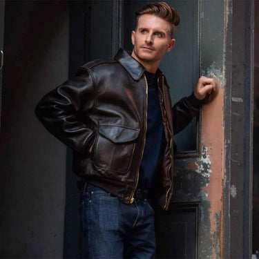Model wearing Cockpit USA Men's 100 Mission A-2 leather flight jacket in urban setting