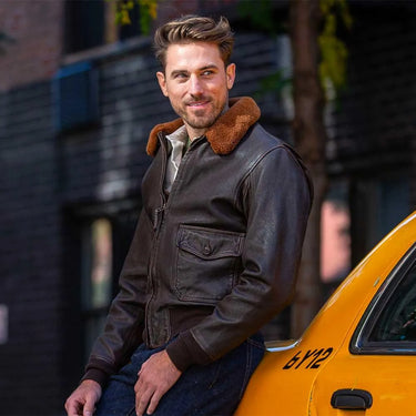 Model wearing Cockpit USA Men's 100 Mission G-1 Aviator Leather Flight Jacket in urban setting
