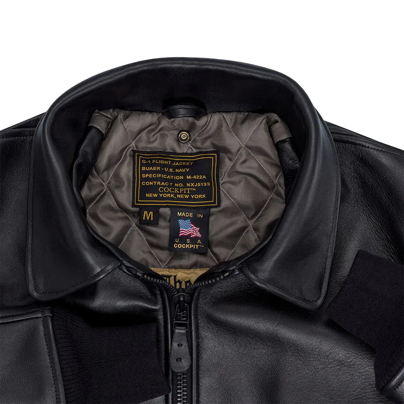 Close-up of a Cockpit USA men's G-1 antique lambskin leather flight jacke with quilted lining and visible branding on a white background