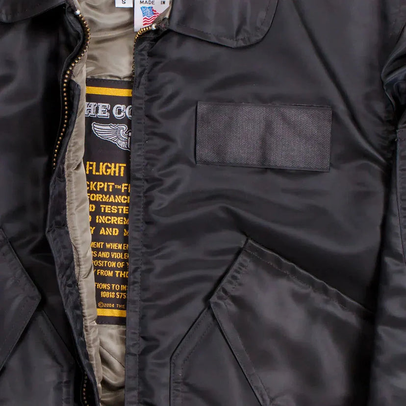 Close-up of chest and pocket details on Cockpit USA Men's black CWU-55/P Flight Jacket