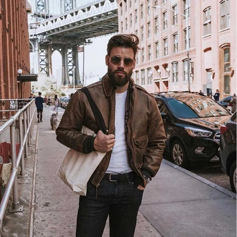 Man wearing Mustang Vintage A-2 jacket on city street with sunglasses and tote bag