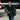Model wearing the Cockpit USA Men's R.A.F. Sheepskin Bomber Jacket in black by aircraft