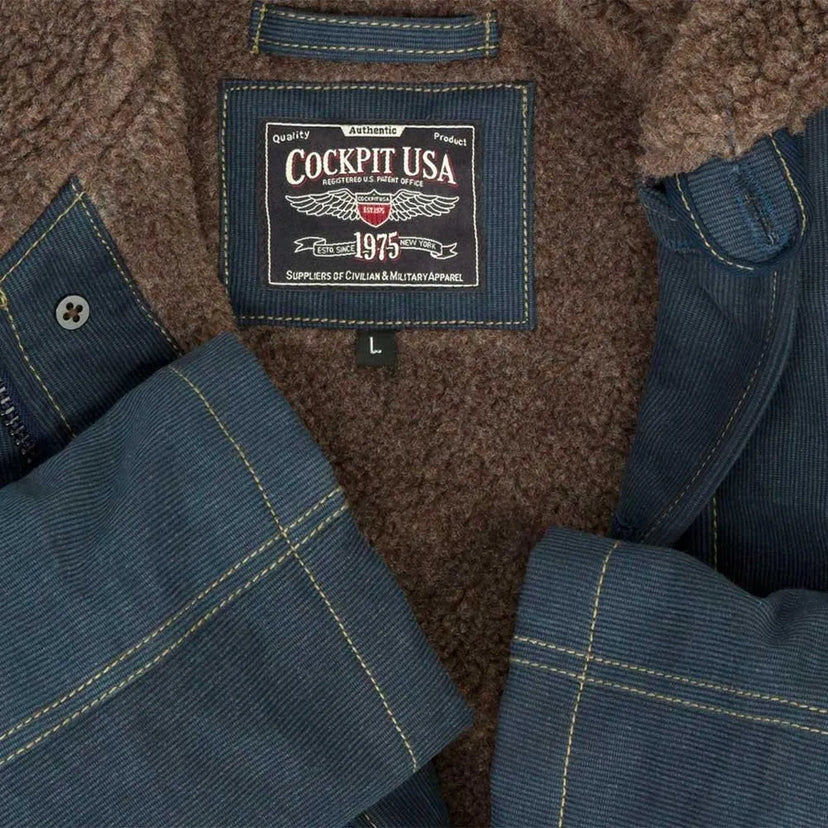 Close-up of Cockpit USA label stitched into the Men's N1 Bedford Cord Deck Jacket in navy