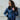 Female model wearing the Cockpit USA B-15 Jacket outdoors, styled casually with jeans.