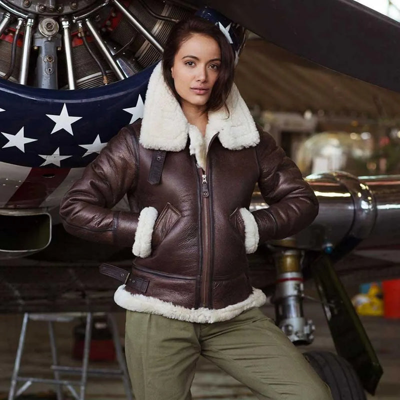 Model wearing Cockpit USA Women's B-3 Sheepskin Bomber Jacket in hangar setting