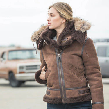 Woman wearing the Cockpit USA Hooded B-3 Bomber Jacket in brown suede and sheepskin outdoors