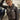 Female model wearing Cockpit USA Women’s WASP A-2 Lambskin Jacket posing beside aircraft