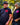 Man and woman wearing Legendary Color Shield Motorcycle T-Shirts outdoors, showcasing fit and red/pink logo, Made in USA