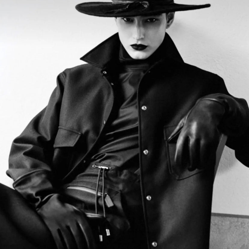 Black and white high-fashion portrait of a model in all-black outfit wearing Legendary USA deerskin gauntlet gloves