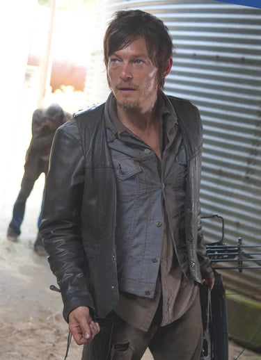 Man wearing a black leather motorcycle vest styled in a rugged outdoor setting