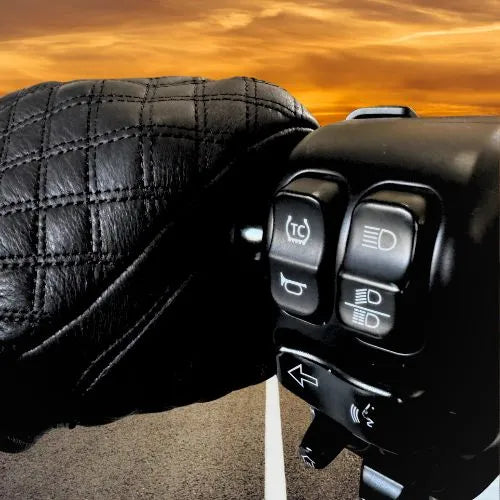 Legendary Double-Diamond Glove gripping motorcycle controls at sunset, showing quilted leather detail and fit, made in USA