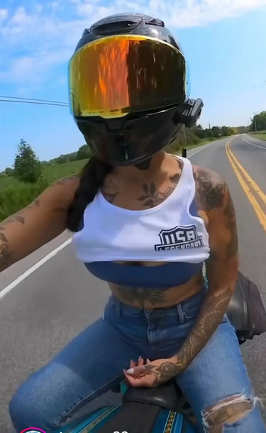 On-model view of Legendary USA white motorcycle tank top worn while riding, showing USA Legendary chest logo