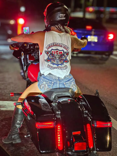 Woman riding motorcycle at night wearing Legendary USA x Evil1 Kustoms 4th of July white tank top with patriotic back graphic, made in USA