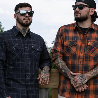 Legendary No Life series men’s black and white flannel shirts worn outdoors by two men wearing sunglasses