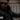 Bearded rider wearing distressed horsehide cafe racer leather motorcycle jacket on a bridge