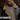 Bearded model wearing authentic B-3 sheepskin bomber jacket with shearling collar in city alley