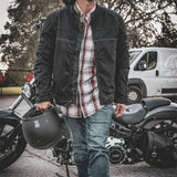 Construction detail of men's mesh motorcycle jacket, highlighting stitching and material grain