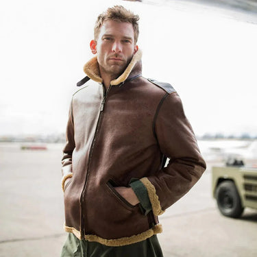 Model wearing Cockpit USA Men's B-6 Shearling Bomber Jacket on airstrip with hands in pockets