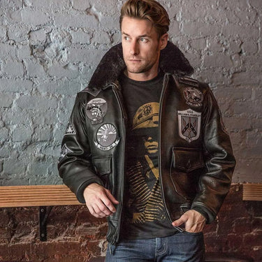 Male model wearing Cockpit USA Bogard Stealth G-1 Jacket against a brick wall, showcasing patch and collar details