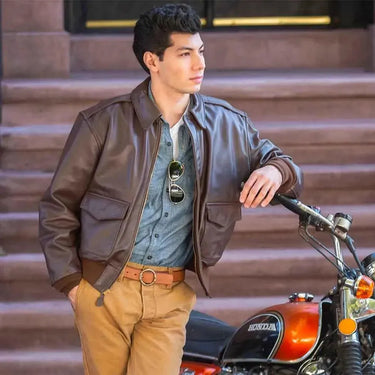 Model wearing Cockpit USA Men's Horsehide A-2 flight jacket near motorcycle