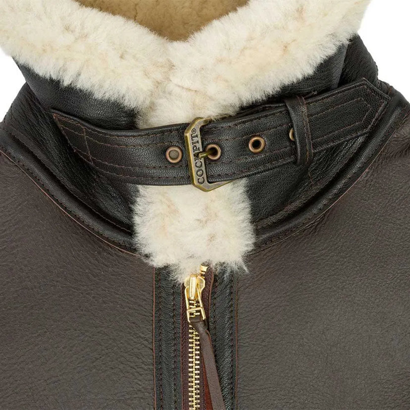 Close-up of shearling collar with leather throat latch strap and brass buckle on the Champ Jacket
