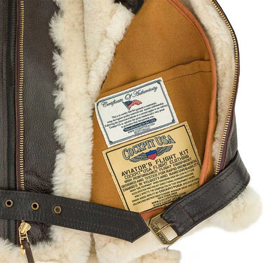 Close-up of Cockpit USA authenticity and flight kit labels inside the men's bomber jacket