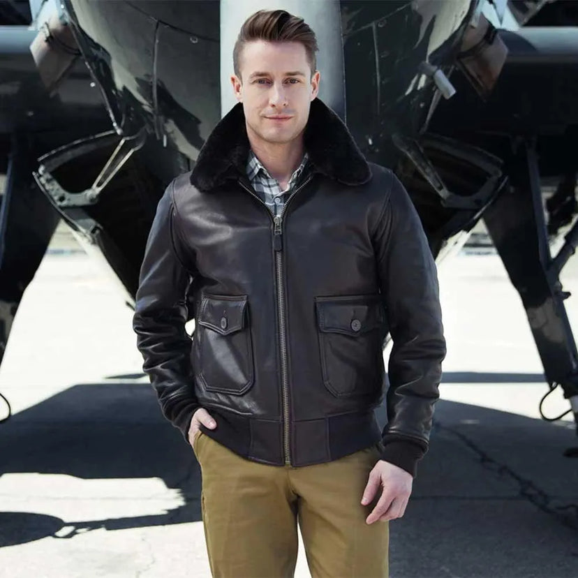 Male model wearing the G-1 Calfskin Leather Jacket standing in front of an aircraft