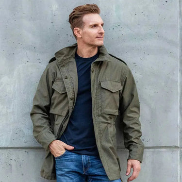 Model wearing Cockpit USA Men's M65 Field Jacket outdoors
