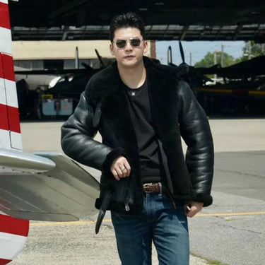 Model wearing the Cockpit USA Men's R.A.F. Sheepskin Bomber Jacket in black by aircraft