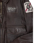 Close-up of front pocket with patch and button detail on the Cockpit USA Vietnam Flight Jacket.