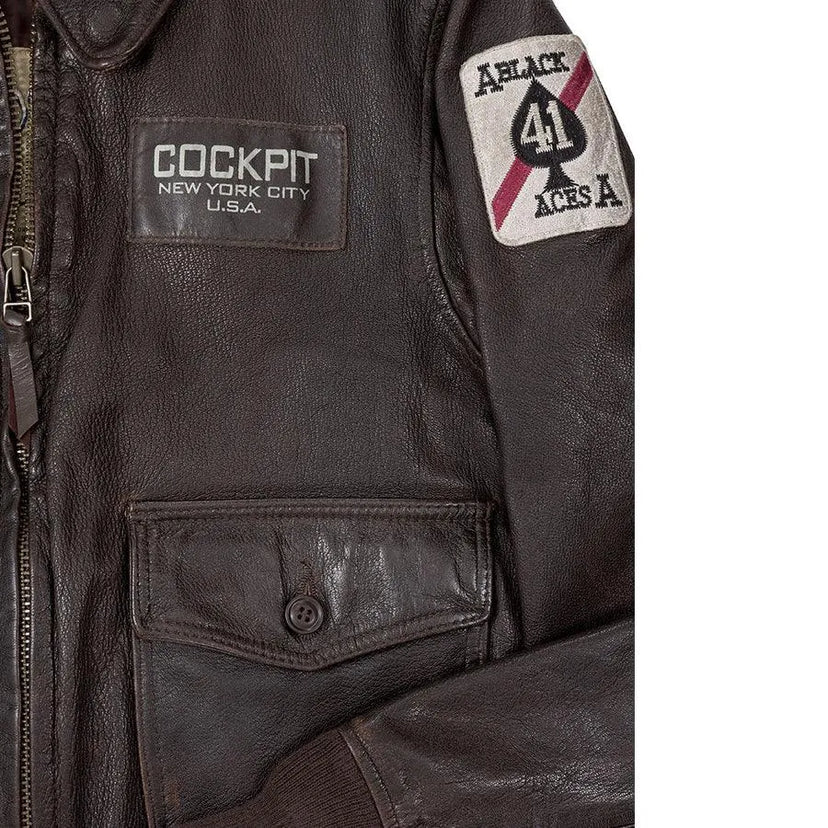 Close-up of front pocket with patch and button detail on the Cockpit USA Vietnam Flight Jacket.