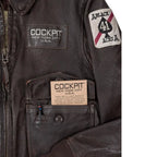 Open front pocket showing Cockpit USA brand card and pen loop feature.