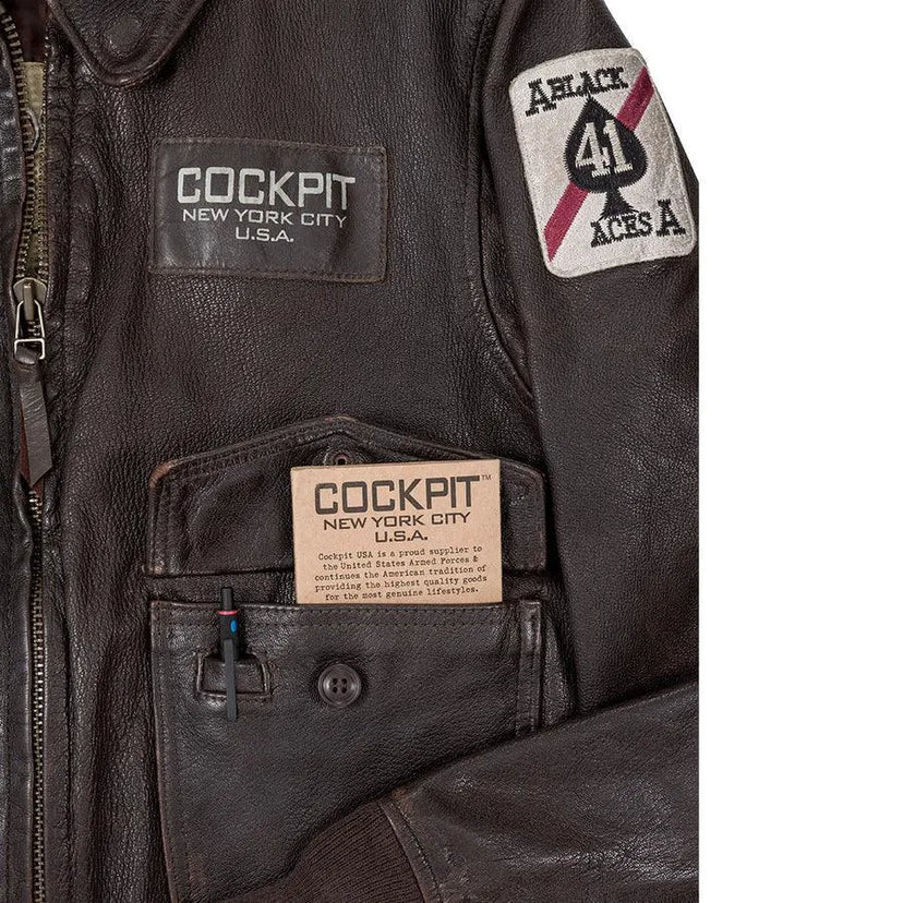 Open front pocket showing Cockpit USA brand card and pen loop feature.