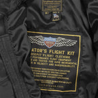 Close-up of interior flight kit label with wings logo and branding in gold on the Cockpit USA jacket.