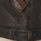 Close-up of Cockpit USA leather patch and waist buckle detail on Women's B-3 Jacket