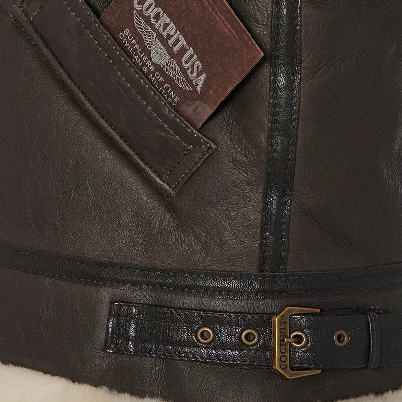 Close-up of Cockpit USA leather patch and waist buckle detail on Women's B-3 Jacket