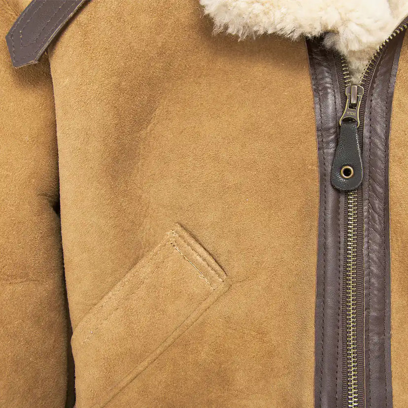 Close-up of front pocket and zipper details on the tan Cockpit USA Women’s Hooded B-3 Bomber Jacket
