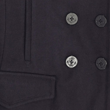 Close-up of anchor-embossed buttons and pocket details on the Cockpit USA Women's Navy Peacoat.