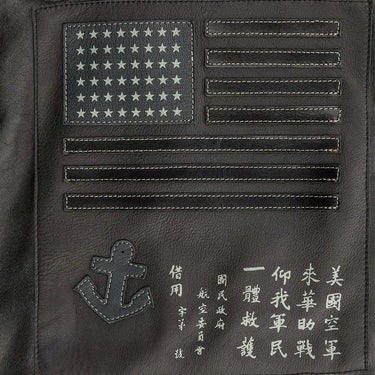 Close-up of back embroidery showing flag, anchor, and detailed stitching on the jacket.