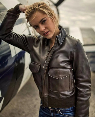 Female model wearing Cockpit USA Women’s WASP A-2 Lambskin Jacket posing beside aircraft