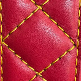 Close-up of red cowhide leather belt with yellow diamond stitching, showcasing quilted texture, Made in USA