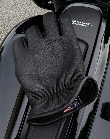 Fleece-Lined Deerskin Gloves shown in a riding setting made in USA, a motorcycle glove