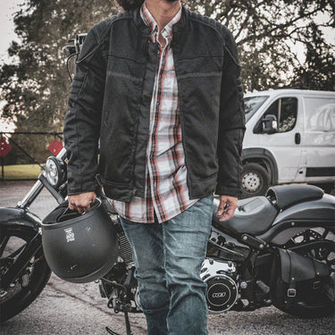 Construction detail of men's mesh motorcycle jacket, highlighting stitching and material grain