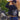 Woman wearing Legendary USA Booty Call cropped motorcycle hoodie, back view showing bold biker graphic, next to motorcycle