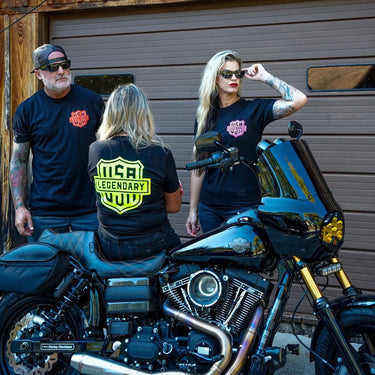 Group of riders wearing Legendary Color Shield Motorcycle T-Shirts near Harley-Davidson bike, showcasing bold colors, Made in USA