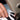 man sewing Legendary USA spitfire gloves with a sewing machine