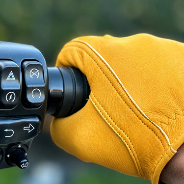 Gold Short Wrist Cuff Deerskin Gloves shown in a riding setting made in USA, a motorcycle glove