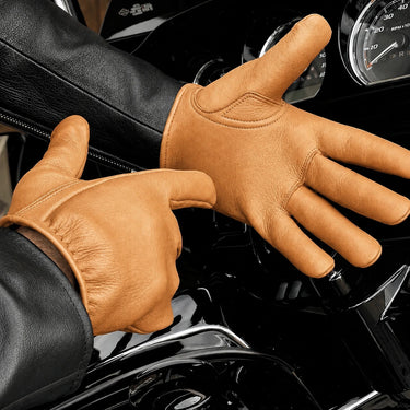 Tan Short Wrist Deerskin Gloves shown in a riding setting made in USA, a motorcycle glove