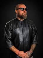 Model wearing the Legendary '3 Quarter Order' premium perforated cowhide riding shirt — collarless club-style fit, studio view